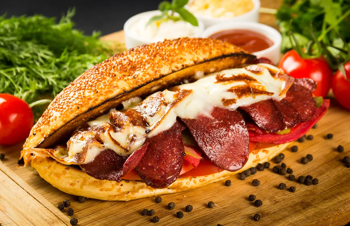 Sandwich with salami and melted cheese.